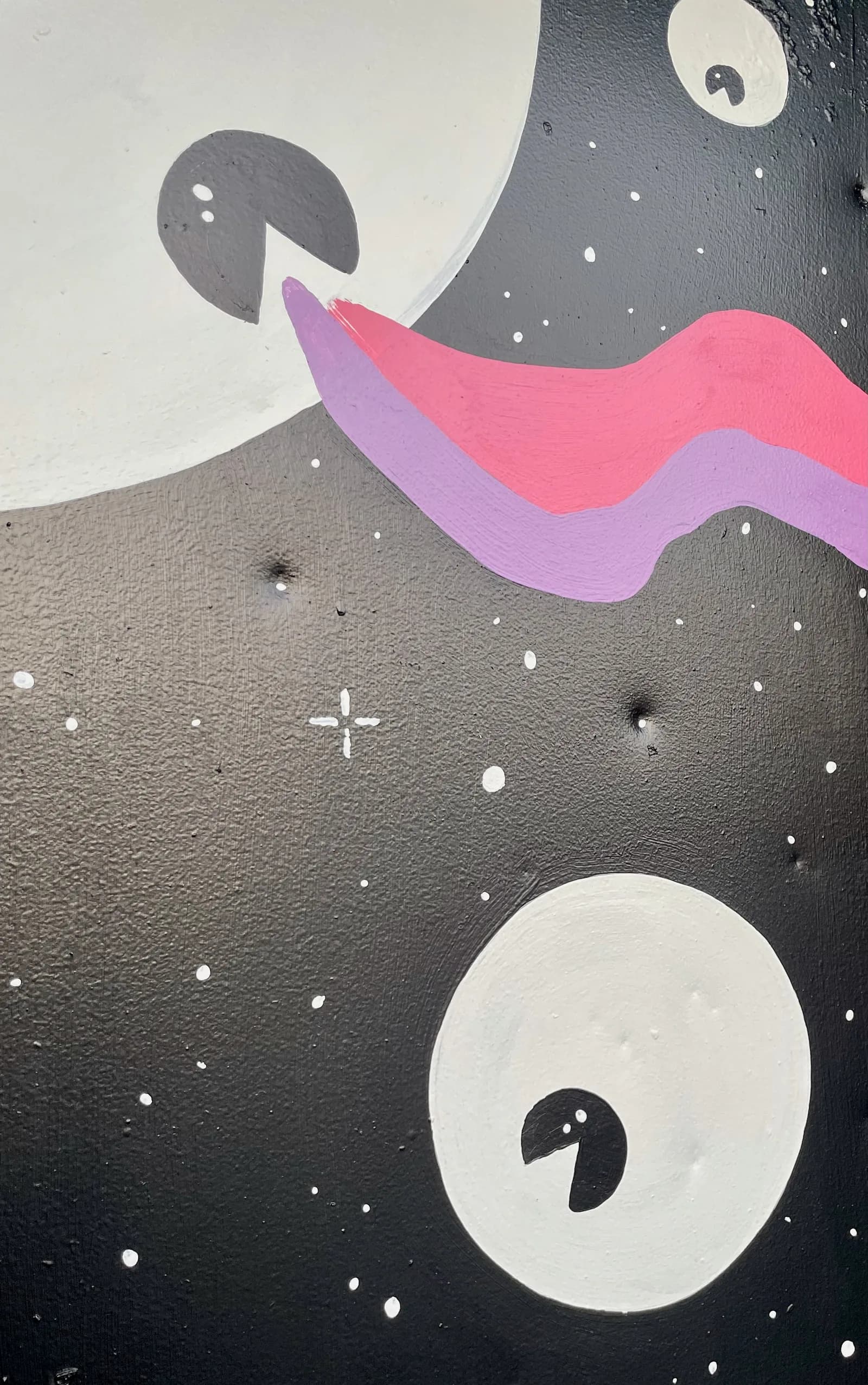 Detail of the “Searchin'” mural — white crescent-moon eyes and a pink-and-purple ribbon across a starry black field