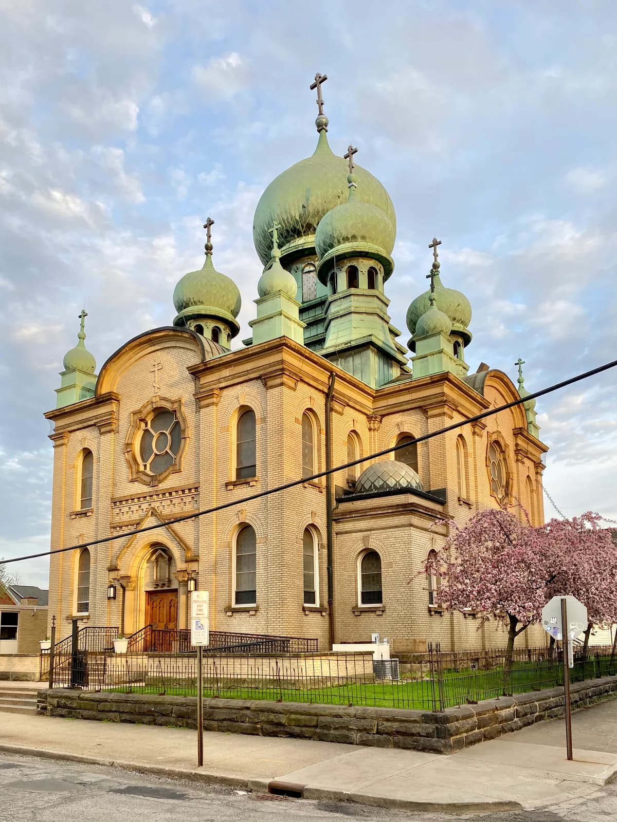 St. Theodosius Russian Orthodox Cathedral in Tremont, its copper onion domes and yellow-brick facade lit at golden hour